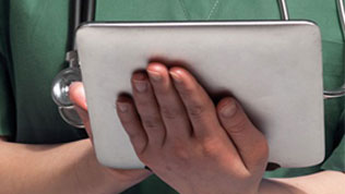 A vet holding a digital tablet