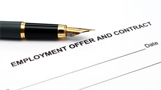 An unsigned employment contract, with a fountain pen on top of it