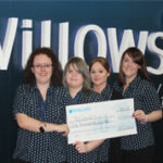 Four people holding a donation cheque from Willows Veterinary Centre, at BSAVA Congress