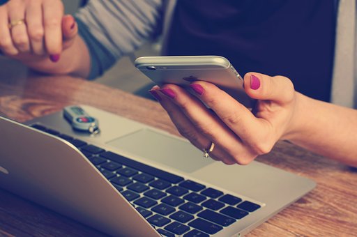 Person looking at a mobile phone and laptop, while using the BSAVA website